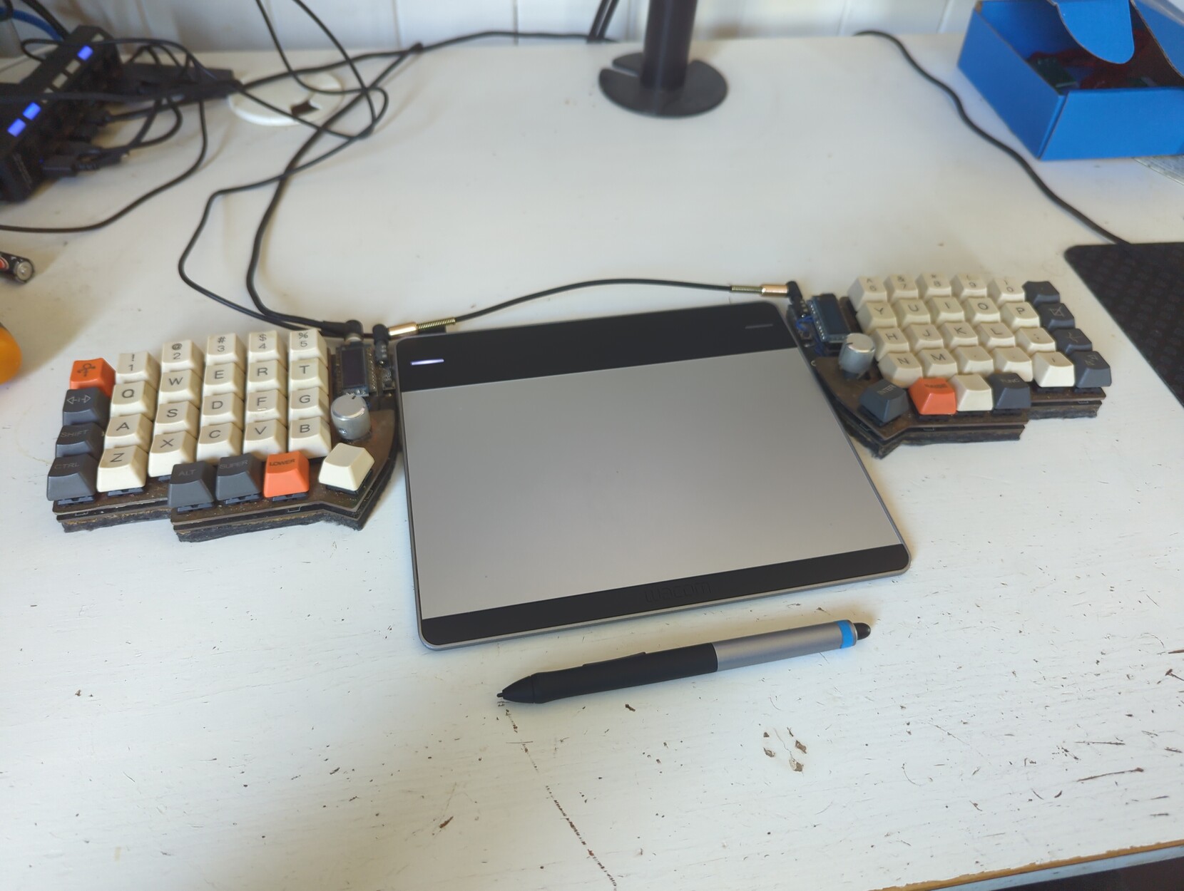 Homemade split keyboard and drawing tablet on a desk